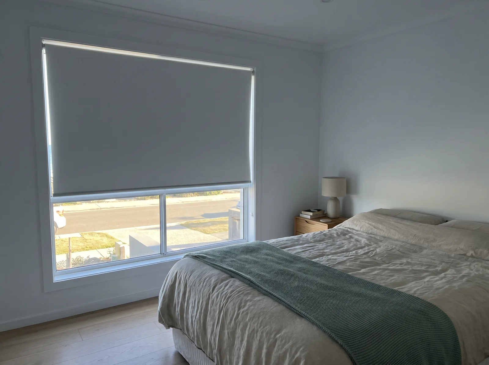 Blockout blind holding back hard morning sun in a beach-suburb bedroom